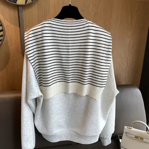 Detailed back view of grey knit sweatshirt with striped shawl layering and ribbed cuffs