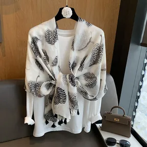 Lightweight grey scarf with leaf and leopard print featuring fringe tassels and soft fabric