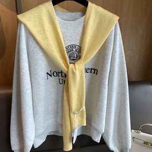Gray sweatshirt with yellow knit shawl featuring Northwestern University logo