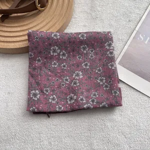 Detail of vintage floral small silk scarf on soft white fur with a leather belt accessory