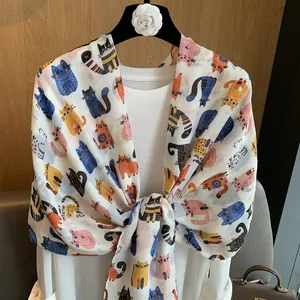 White cotton linen scarf featuring colorful cartoon cat prints for a playful autumn look