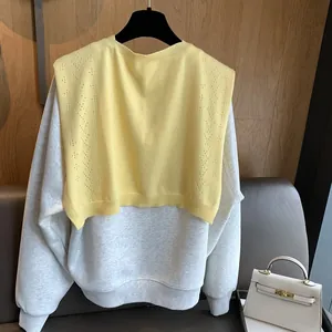 Women's light grey sweatshirt with a pale yellow hollow knit shawl overlay
