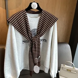 Classic grey college sweatshirt with a brown striped knit shawl and school crest