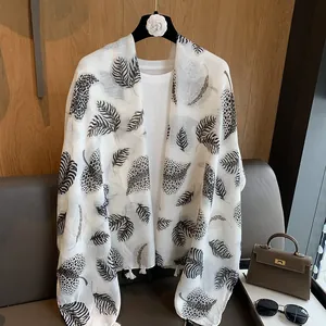 Elegant cotton linen scarf with leaf and leopard print patterns and fringe trim