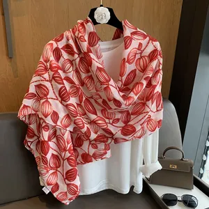 Dettaglio macro della stampa vegetale rossa su sciarpa in chiffon color avorio leggero
