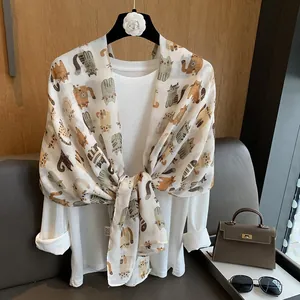 Close-up of cartoon cat print on a soft cream cotton linen shawl scarf for women