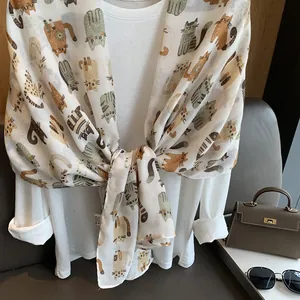 Detail shot of lightweight cotton linen scarf featuring cute cartoon cat print pattern