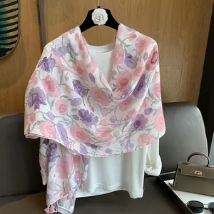 Détail du châle en soie à fleurs avec glands délicats sur un cintre chic