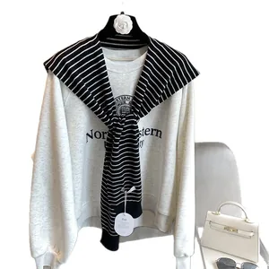 Grey Northwestern University sweatshirt styled with striped knit shawl as an accessory