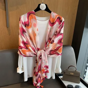 Detail of bohemian wavy print cotton scarf with colorful fringes on a display hanger