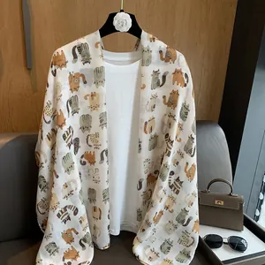 Detail of a lightweight linen scarf featuring a cute cartoon cat print for women