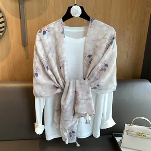 Floral cotton linen scarf with red berry prints and fringe tassels on a white top