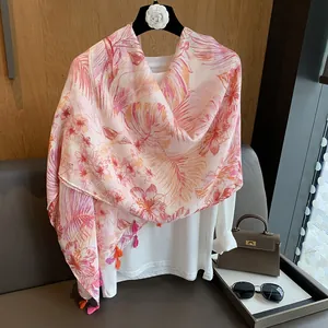 Close-up of tropical floral print scarf with colorful fringe on white t-shirt