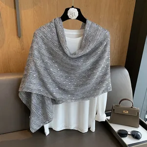 Detail showing high-end black and white striped linen scarf with gold sequin highlights
