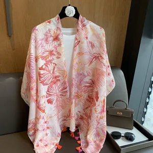 Detail of lightweight floral chiffon shawl with tropical hibiscus and orange tassels