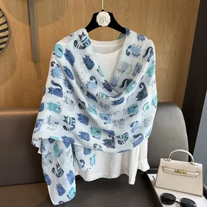 Detailed view of hand-drawn cartoon cat prints on breathable white linen scarf fabric