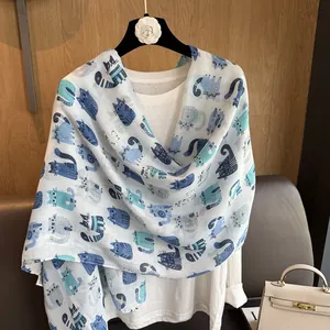Detailed view of white cotton linen scarf with cute blue cartoon cat prints for women