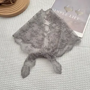Close-up of grey floral lace headband featuring intricate embroidery and scalloped edges