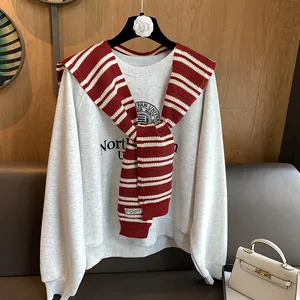 Red striped knit shawl paired with a gray sweatshirt for a casual college look