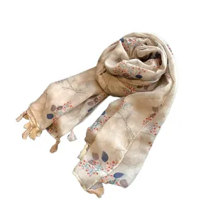 Floral cotton linen scarf with red berry print and tassels on a clean white background
