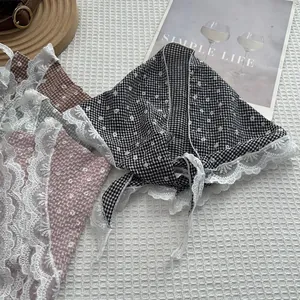 Dettaglio del foulard a quadretti floreali con ampi bordi in pizzo e tessuto traspirante