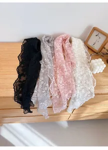 Detailed embroidery on colorful lace silk scarves in black, grey, pink, and beige