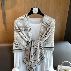 Ethnic feather print scarf shawl in beige and brown over a white shirt display