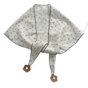 White floral cotton triangle scarf with brown wavy edges and crochet flower charms