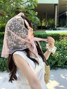 Detail of pink lace mesh headscarf with floral embroidery and scalloped edges
