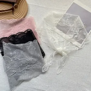 French retro lace triangle scarf with floral embroidery in multiple colors on a textured background