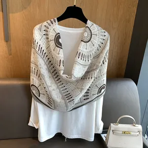 Detail of vintage ethnic print scarf in beige with geometric patterns over a white shirt