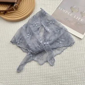 Detailed embroidery on light blue floral lace triangle headscarf for a retro look