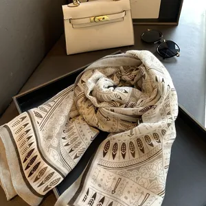 Detailed view of ethnic print scarf with boho feather and geometric floral patterns
