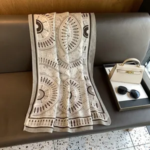 Detailed pattern of bohemian shawl with ethnic geometric prints and feather motifs