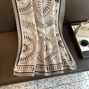 Detail view of ethnic bohemian print scarf with intricate feather and arrow patterns