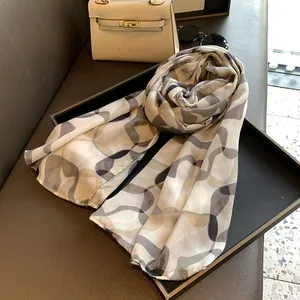 Detail shot of lightweight abstract wave print scarf with premium machine-hemmed edges