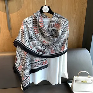 Detailed view of lightweight shawl featuring ethnic patterns and feather geometric motifs