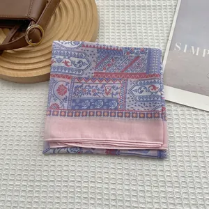 Close-up of baroque printed floral linen scarf with colorful bohemian patterns and hemmed edges