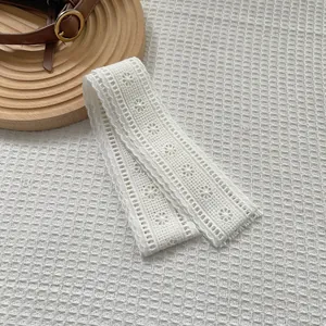 Macro detail of elegant white floral lace scarf with embroidery and scalloped edges