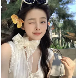 Close-up of sweet white lace necktie with floral hairpin for summer vacation outfits