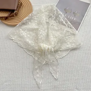 Elegant white lace bandana with floral embroidery and scalloped edges on lifestyle backdrop