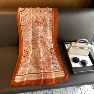 Close-up of vintage mandala print scarf draped on leather sofa with luxury accessories