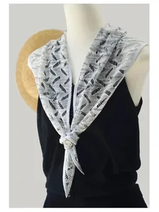Detail of hollow knit cooling shawl with geometric diamond pattern and white trim