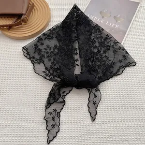 Elegant black lace floral embroidery triangle scarf displayed on a white textured background