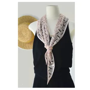 Detail view of pink tie-dye hollow lace scarf showing delicate knit pattern on a mannequin