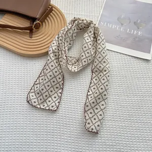 Detail of vintage floral cotton linen skinny scarf with brown wavy stitched edges