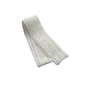 Elegant white embroidered floral lace ribbon with intricate scalloped edges and cutout details