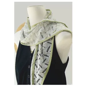 Detailed macro view of light green hollow-out crochet pattern and satin trim on this scarf