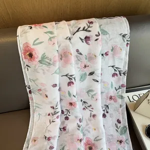 Detail of floral chiffon scarf with pink blossoms and subtle silver glitter texture