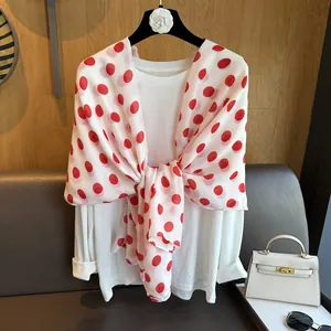 Detail shot of a white lightweight shawl featuring elegant large red polka dots patterns